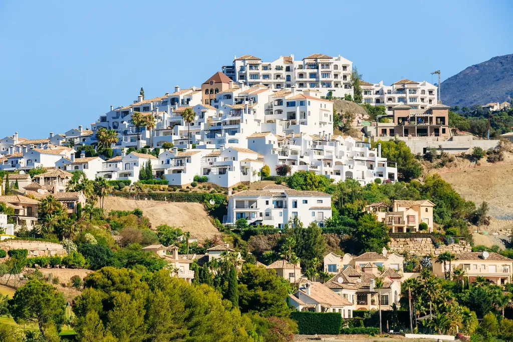 The white village of Benahavís on its hill among trees