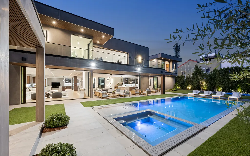 Contemporary villa with glazed living spaces and a pool in daylight