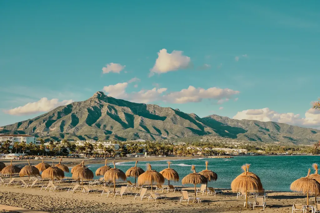 La Concha mountain above the beach at Puerto Banús with thatched parasols