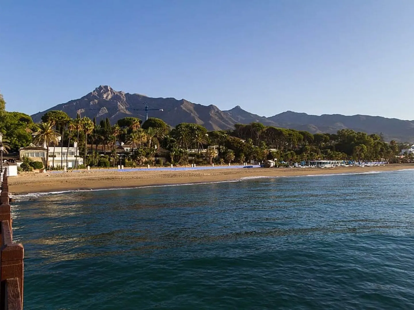 Lucas Fox: the beach at Nagüeles in Marbella with the mountains behind