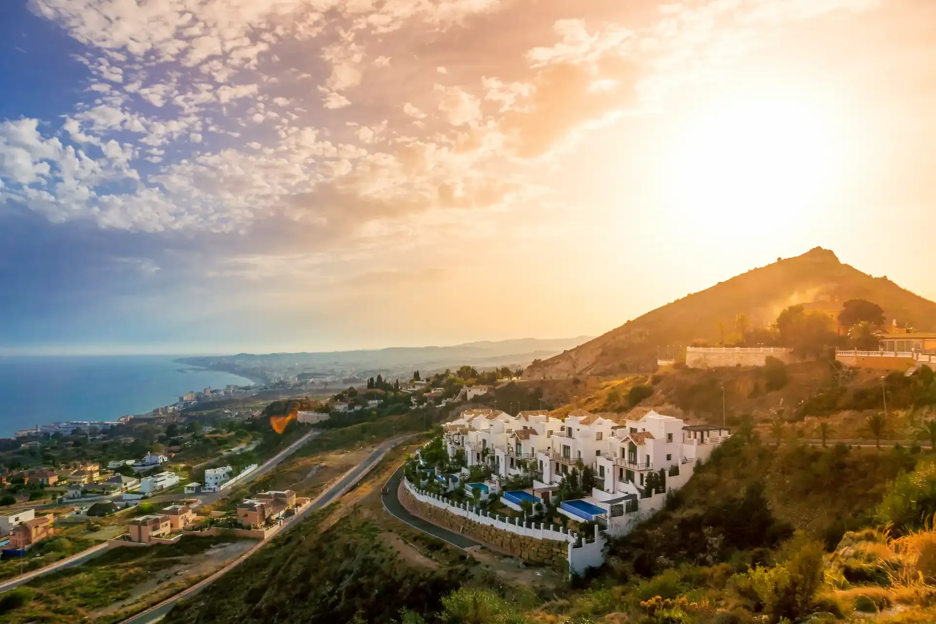 Hillside villas above the coast at sunset near Marbella