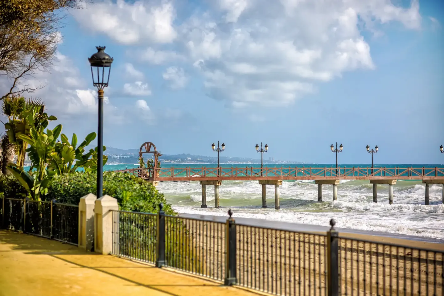 Wooden pier and lantern on the Marbella seafront promenade