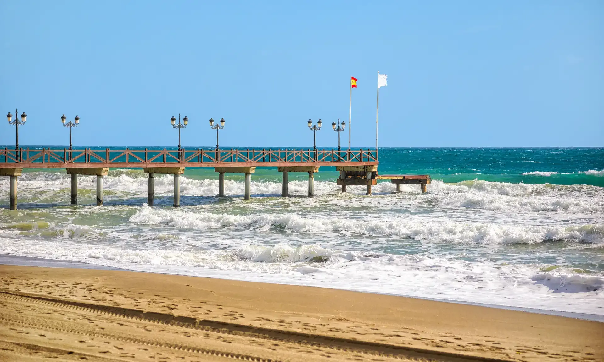 Wooden pier over a turquoise sea on the Marbella coast