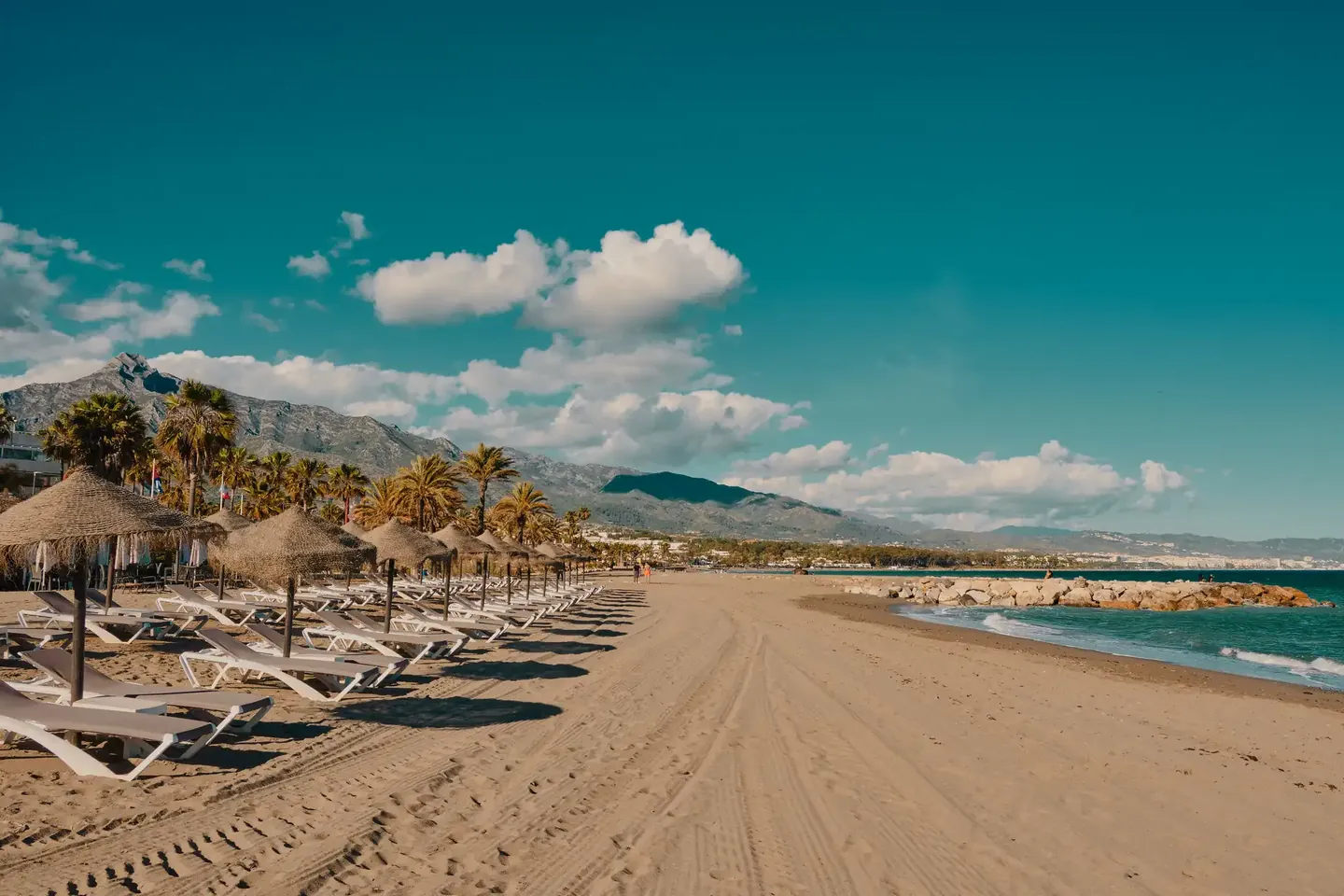 Sun loungers and parasols on the beach at Puerto Banús