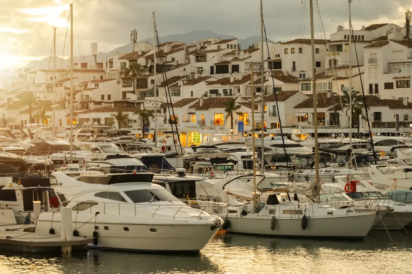 Yachts moored in Puerto Banús harbour in the evening light