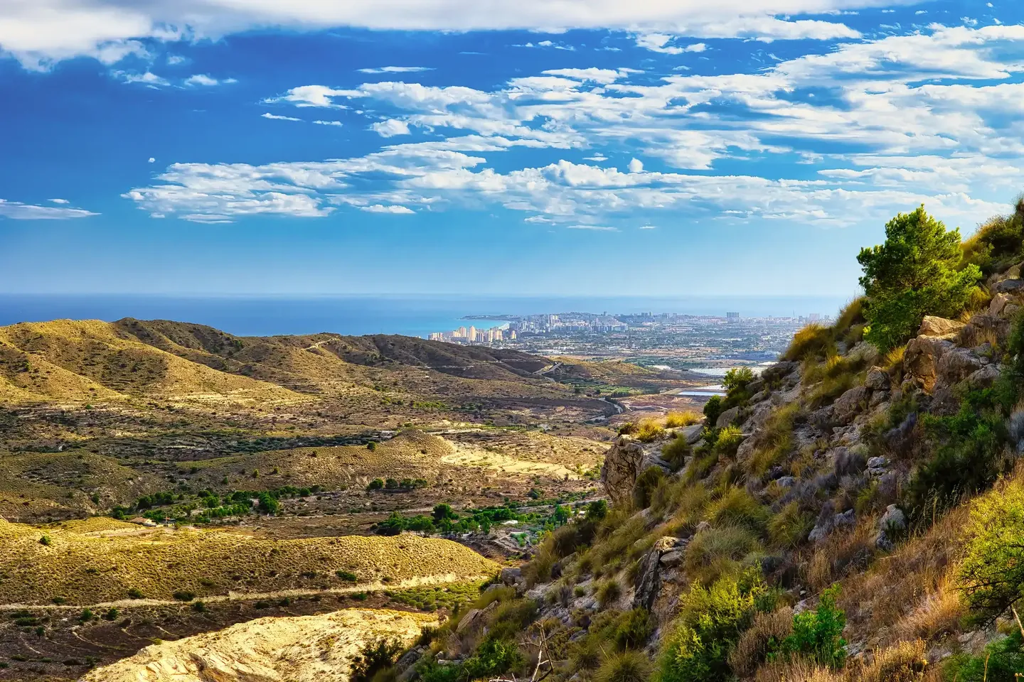 View from the hills over green slopes to the Costa del Sol